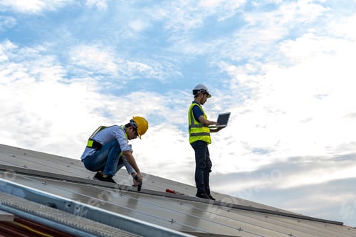 Preview: Engineer service check installation solar cell on the roof of factory.
