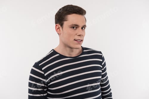 Preview: Facial Expression. Nice Serious Man Standing Against White Background While Looking At You