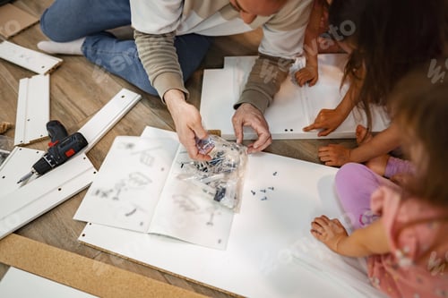 Preview: Family bonding while assembling furniture on a weekend afternoon