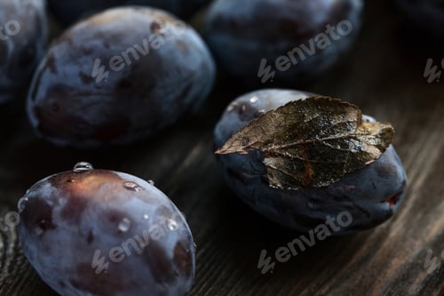 Preview: Ripe Plums with Leaf and Water Droplets