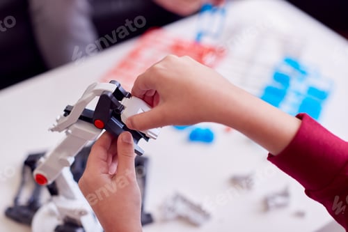 Preview: Close Up Of Boy Wearing Pyjamas Building Robotic Arm From Plastic Kit At Home