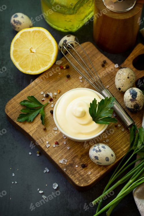 Preview: Homemade mayonnaise sauce on black stone background.