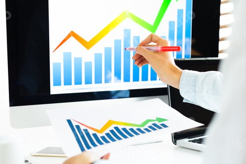 Preview: Business person analyzing data trends with charts and graphs on computer screen