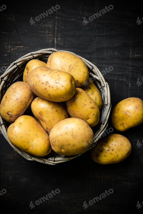Preview: Fresh potatoes. On black background.