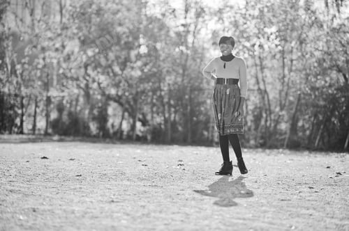 Preview: African american girl at yellow and red dress at golden autumn fall park.