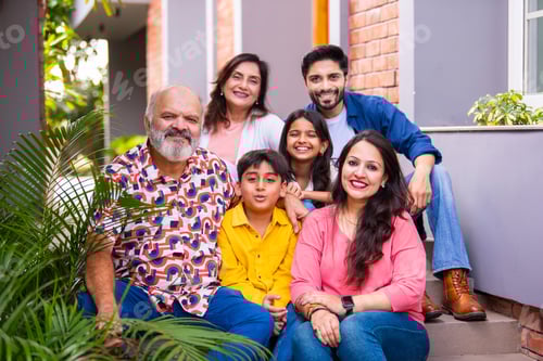 Preview: Indian family enjoying outdoor bonding time on steps during weekend relaxation