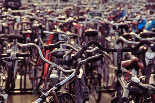 Preview: Closeup shot of bunch of bicycles parked in a main station of Amsterdam, Netherlands