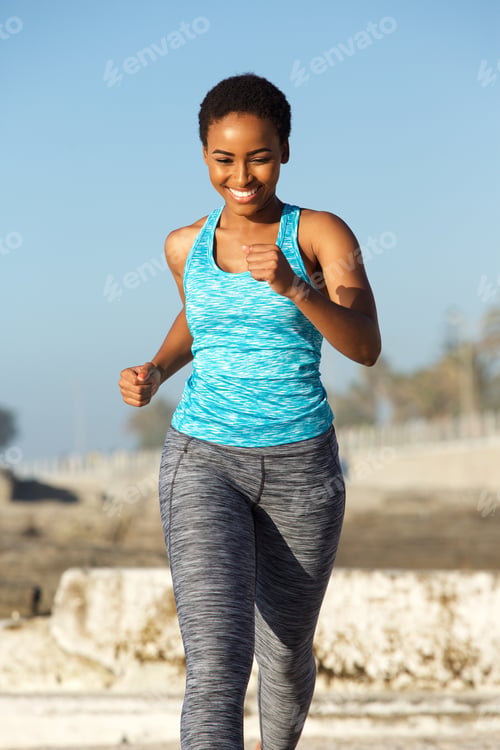 Preview: happy young african american woman running outside
