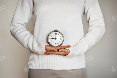 Preview: Time. Female hands hold vintage alarm clock