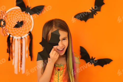 Preview: Girl closing one eye with a bat with a joyful radiant smile