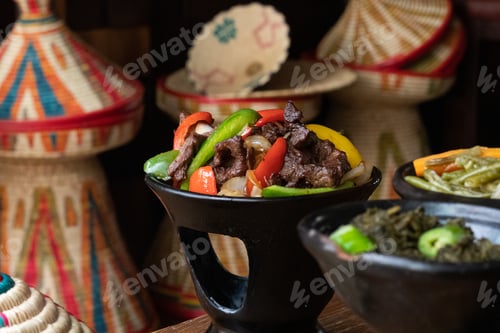 Preview: Selective focus shot of delicious Ethiopian food with fresh vegetables on a wooden table
