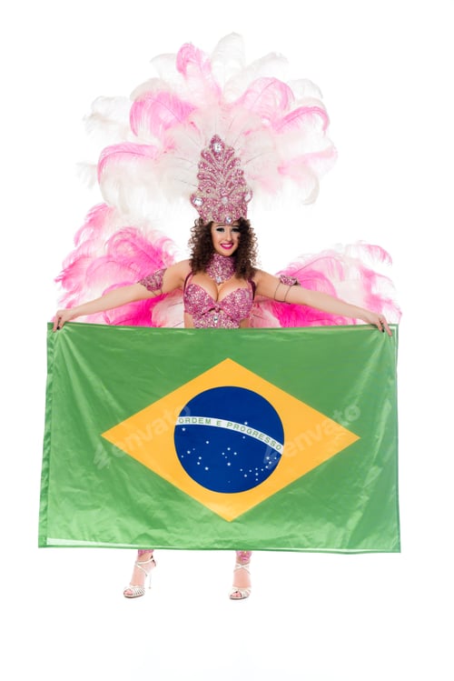 Preview: Happy young woman in carnival costume with pink feathers holds large flag of Brasil isolated on