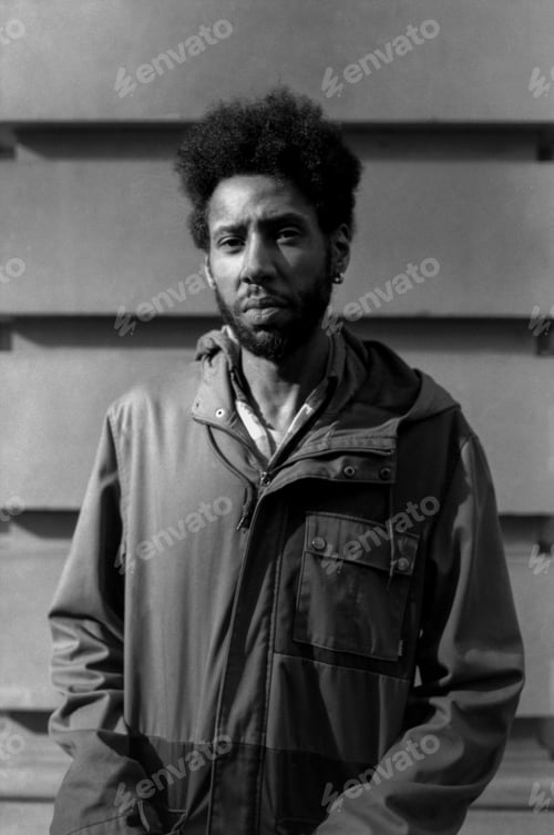 Preview: Young man posing with afro hair in monochrome analog photo