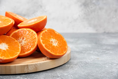 Preview: Sliced juicy fresh orange fruits in a wooden plate