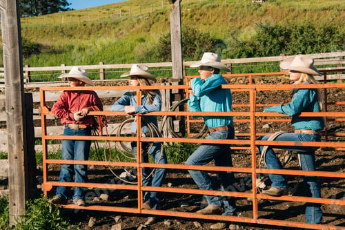 Preview: Cowboys and cowgirls leaning on gate, looking away, Enterprise, Oregon, United States, North America