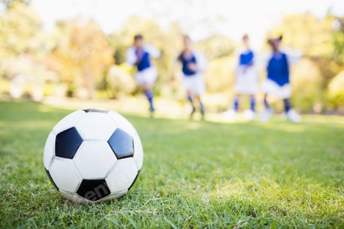 Preview: Extreme close up view of soccer balloon against children background