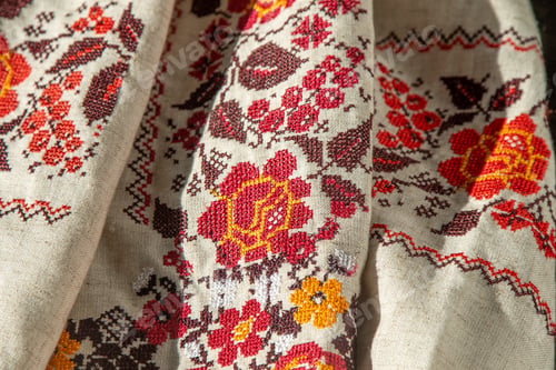 Preview: Ukrainian clothes embroidered shirt. Red orange and black threads background. Vyshyvanka is a symbol