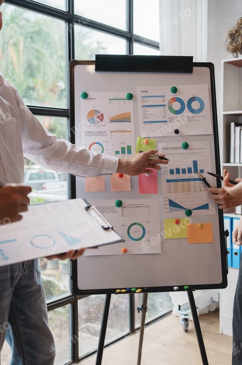 Preview: Meeting of hardworking businesspeople work together as a team by presenting graphs. and charting the
