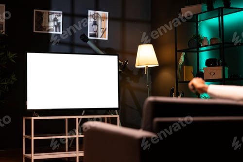 Preview: Man using streaming services on mockup TV to watch movies from the comfort of his personal cinema