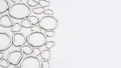 Preview: Metal accessories and supplies for bags, backpacks and sewing laying on a grey background