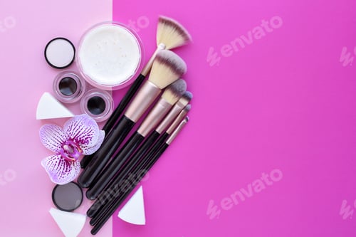 Preview: Makeup brush and decorative cosmetics and a orchid flower on pin