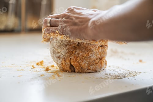Preview: Hands kneading home made pasta or bread dough on kitchen counter