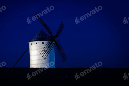Preview: Traditional windmill illuminated against a deep blue night sky. Campo de Criptana, Spain