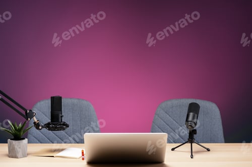 Preview: Podcast studio setup featuring microphones, laptop, and chairs ready for recording