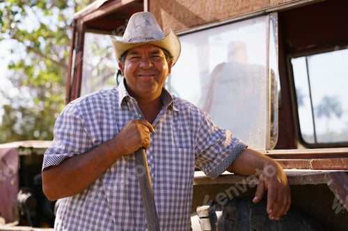 Preview: Portrait Happy Man Farmer Leaning On Tractor Looking At Camera