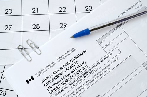 Preview: Application for Canadian citizenship for adults and blue pen lies on calendar page