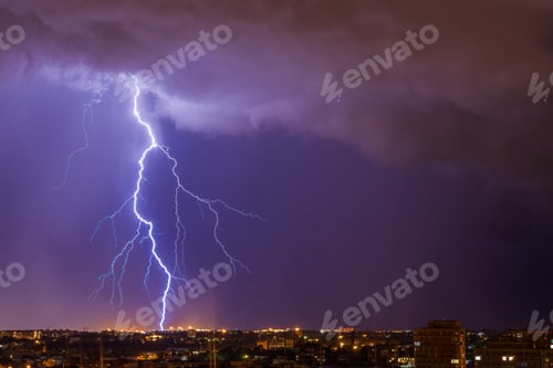 Preview: Lightning under night city. Amazing big lightning strike. Stormy sky, rain, danger