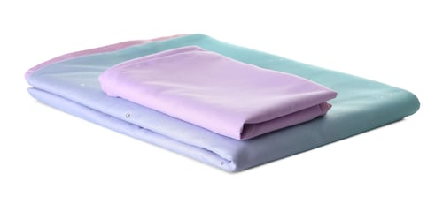 Preview: Stack of clean bed sheets isolated on white