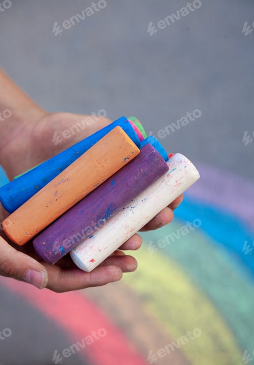 Preview: Colored sidewalk chalks children's hands. Draw on the street. Drawing for kids