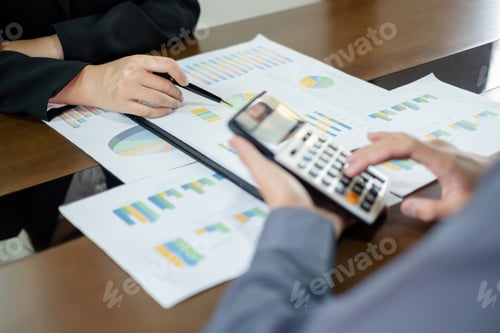 Preview: Two business leaders talk about charts, financial graphs showing results are analyzing