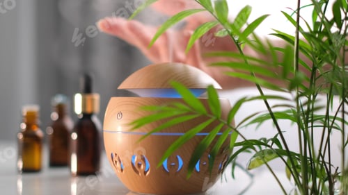 Preview: Modern aroma oil diffuser on the white table. Spa concept for body