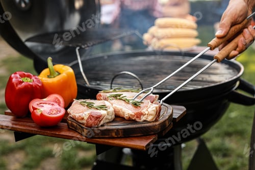 Preview: Man cooking on barbecue grill outdoors, closeup