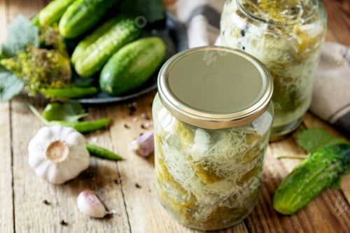 Preview: Salted pickled cucumbers with garlic, preserved canned in glass jar. Home economics.