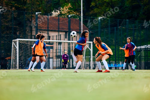 Preview: Young female players during soccer training at the stadium.