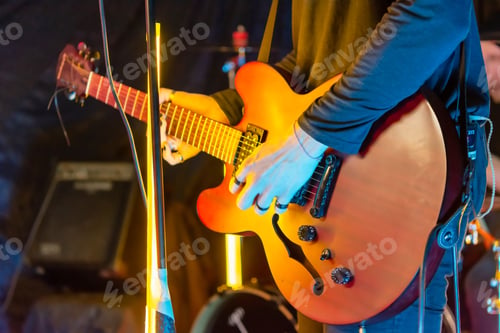 Preview: musician playing the guitar at a rock band concert