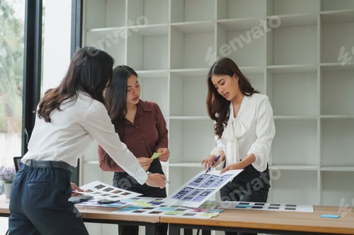 Preview: Web designers working on mockups in office meeting