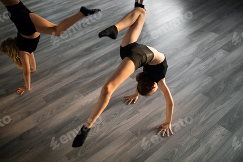Preview: Group of young fit dancers practicing during class school