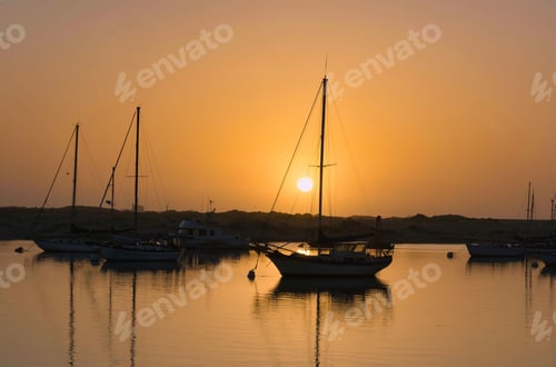Preview: Aerial view of boats riding on sea during sunset