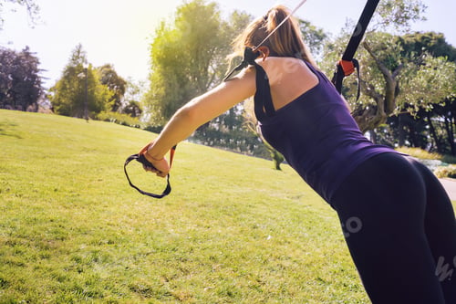 Preview: fitness woman training with suspension straps