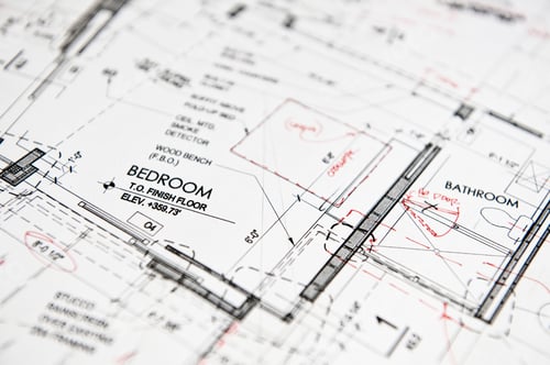 Preview: Closeup of a blue print, architects drawing with red pen alterations,