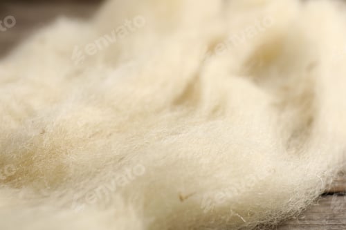 Preview: Natural felting wool on wooden background, closeup