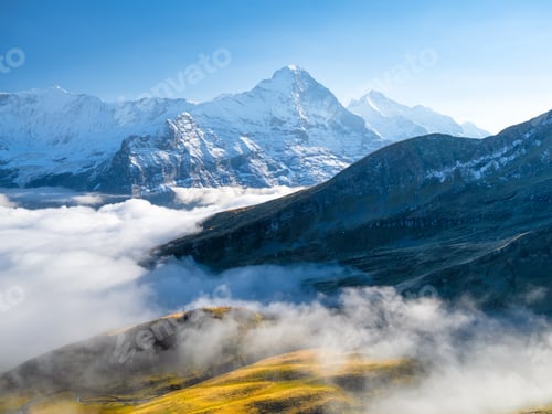 Preview: Mountains peaks and clouds in the valley. Natural landscape.