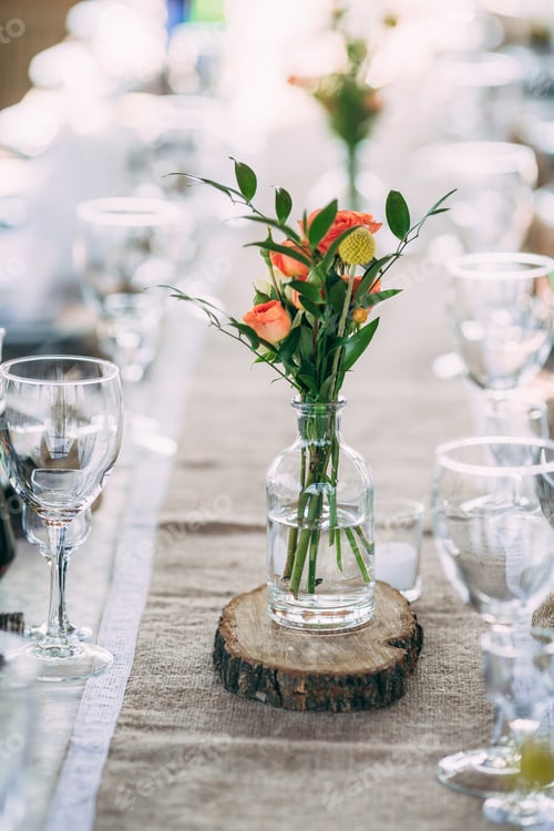 Preview: Flowers in glass on the wedding rusic decorate table