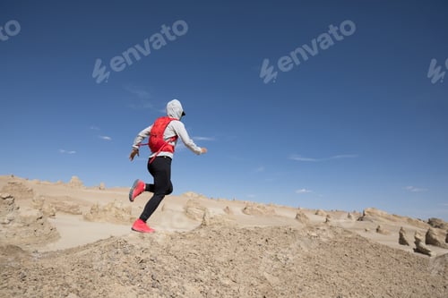 Preview: RunningWoman trail runner cross country running on sand desert dunes