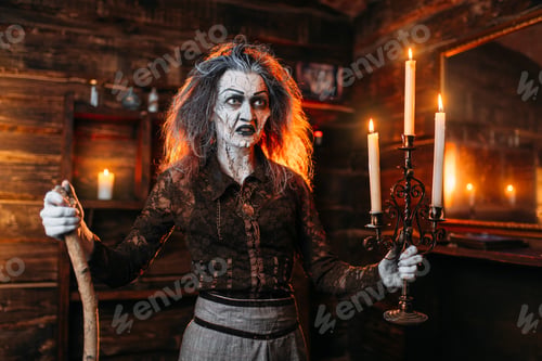 Preview: Scary witch with candlestick and cane reads spell