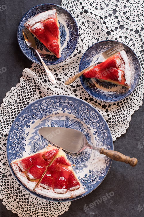 Preview: bright red strawberry pie on blue plates, colorful flat lay festive food, shaped white sallet